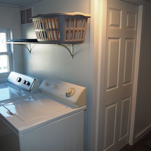 Laundry room:  main floor laundry room with washer, dryer, and sink.