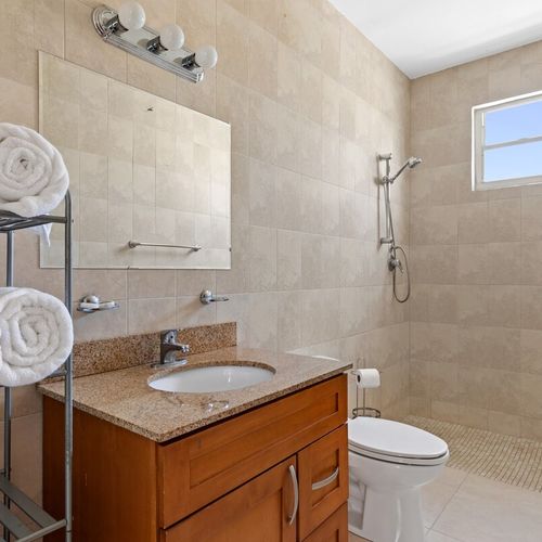 Experience tranquility and unwind in the pristine ambiance of this inviting bathroom sanctuary.