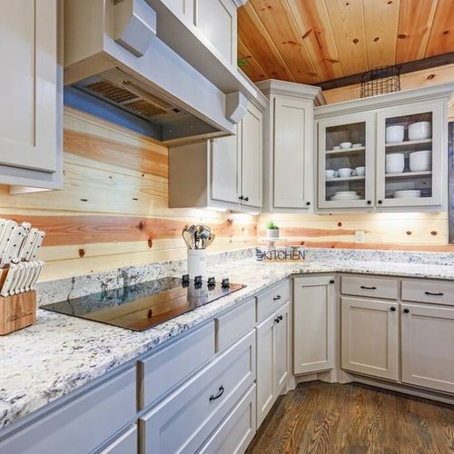 The white cabinets and stone countertops add brightness to the home.