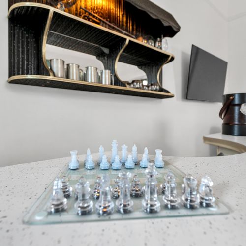 Curated bar shelf stocked w/ glassware & everything you need to mix a great drink.