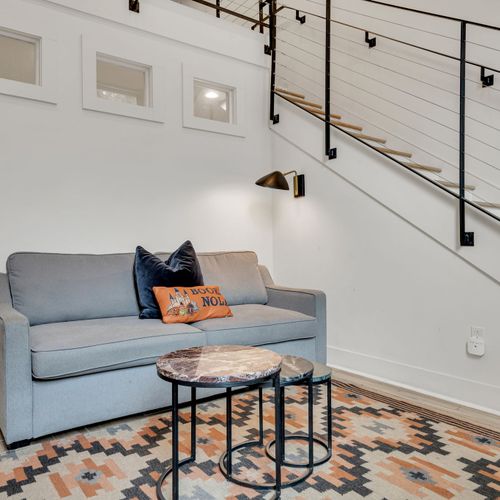 Cozy seating nook w/ chic décor & natural light — a perfect spot to relax.