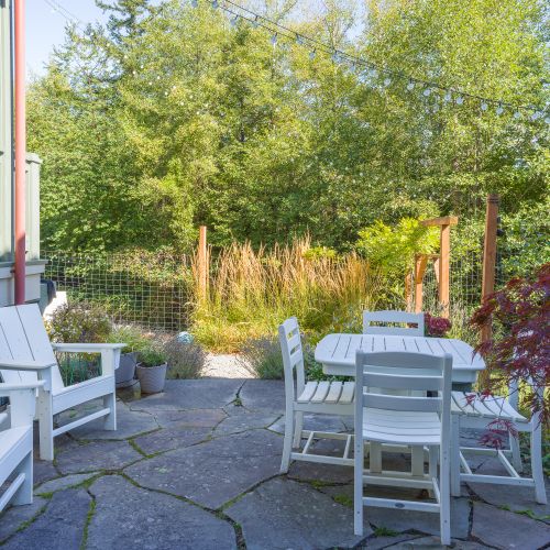 Private stone patio with outdoor dining area.