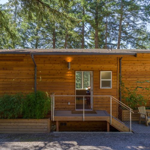 Warm cedar siding, lush bamboo planters, and a welcoming lit entry — Tree Haven greets you like a forest lodge from the moment you arrive