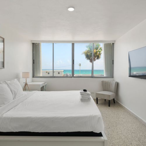 Bright, airy bedroom with inspiring window views. Start your day with natural light and beauty.