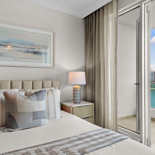 Cozy bedroom with plush queen bed & stylish decor. Your peaceful sanctuary awaits.