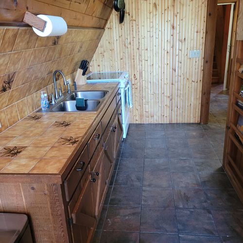 Kitchen:  features an electric range, sink, counter space, cabinets, refrigerator, microwave, and coffee maker. (no dishwasher though. )