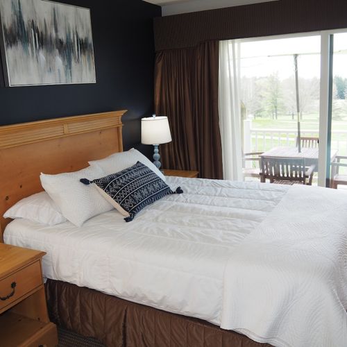 Guest bedroom:  features a queen-size bed, private entrance from the deck, nightstands with lamps, a dresser, closet, chair, and its own television.