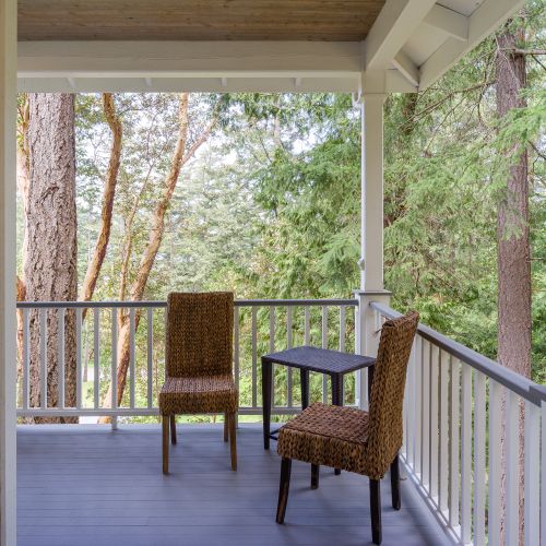 Covered porches wrap around the home on two levels, allowing for quiet time on the porch.