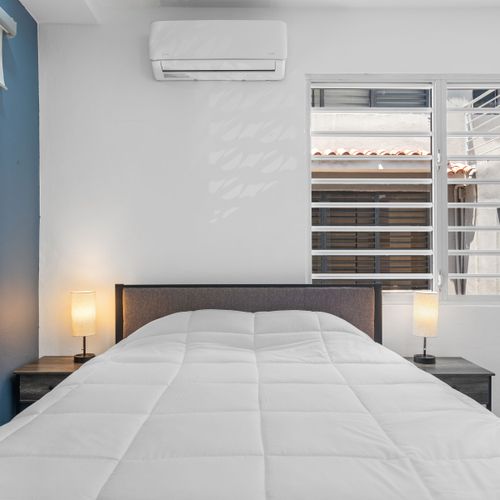 A serene bedroom retreat with ample natural light.