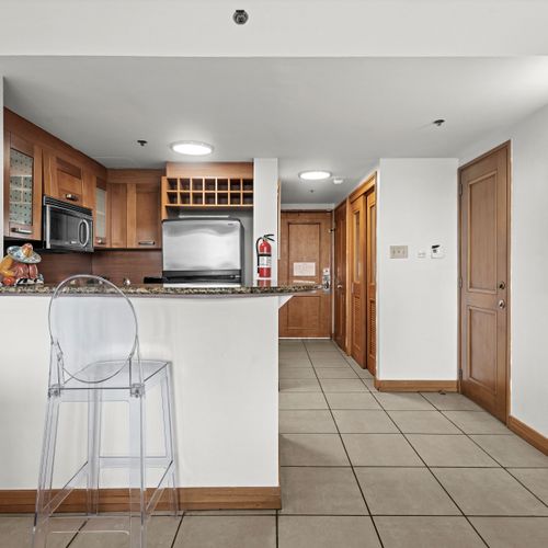 Chic breakfast bar with a clear stool, offering a charming spot for a meal or drink.
