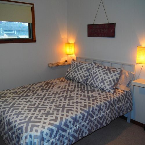 Bedroom #2:  features a full-size bed, bunk bed (i. E. 2 single beds on top of each other), ceiling fan, dresser, mirror, and closet.