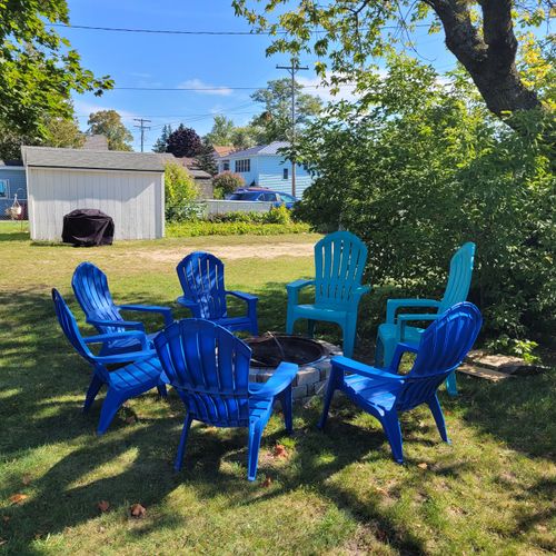 EXTERIOR:  The bonfire ring at the property, with the gas grill in the background.
