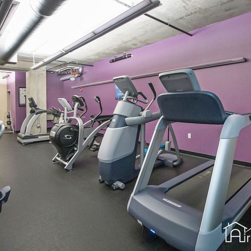 - start your morning strong in the on site fitness center with cardio machines and bikes
- purple feature wall adds a vibrant energy to your workout routine
- everything you need for a run, ride, or cross-training session on site