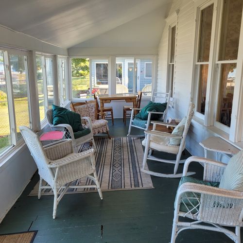 OVERVIEW:  Part of the huge covered front porch, which is great for relaxing and conversing while watching the Crystal Lake.