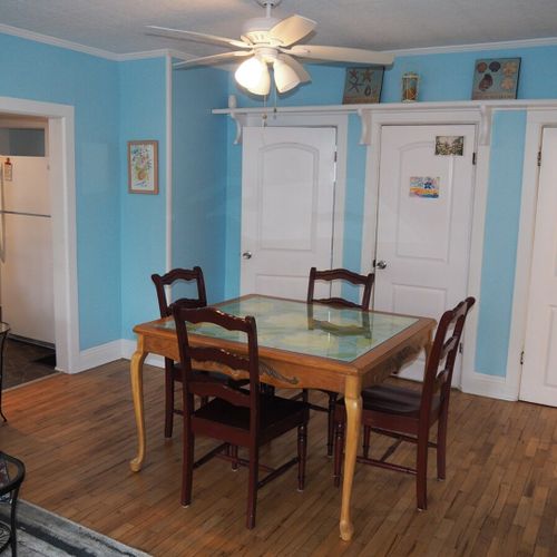 Dining area:  there is a hand-painted square dining table between the kitchen and living room with seating for 4 adults.