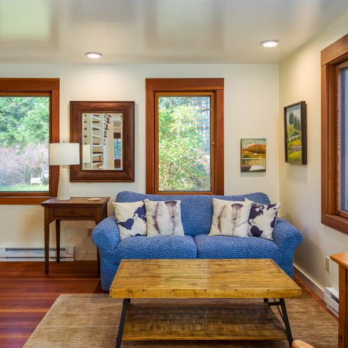 An extra sitting room with stairs that lead to the bedrooms upstairs.