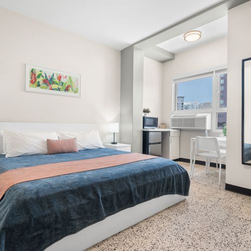 Experience peaceful nights in our tastefully decorated bedroom, featuring a plush bed with crisp linens, ensuring a comfortable and rejuvenating sleep.