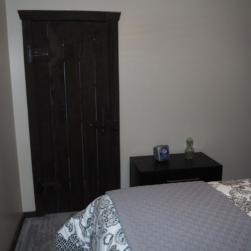 Bedroom #2 (main floor):  features a queen-size bed, ceiling fan, dresser, and closet.