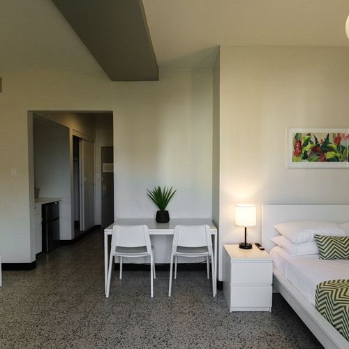 Perfect for small groups or families, this room offers flexible sleeping arrangements with comfortable beds and a cozy seating area, ensuring a harmonious stay for everyone.