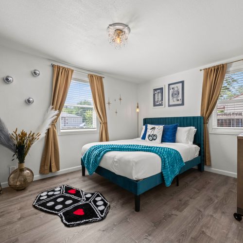 Comfortable second bedroom offers smart tv, work desk, and monitor for convenience.