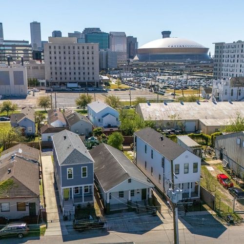 Aerial view showing the home nestled in a lively urban neighborhood.