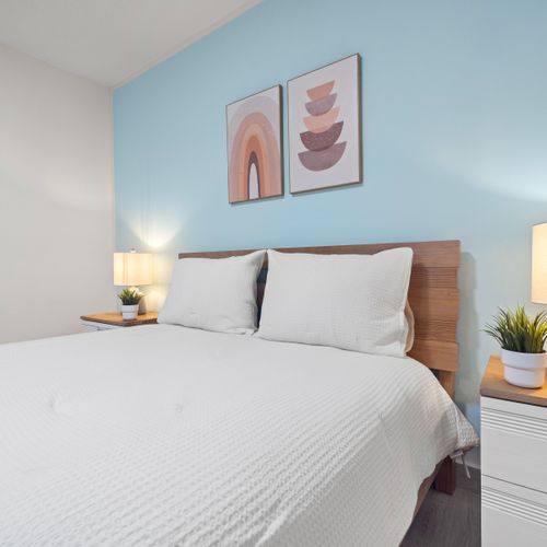 Cozy bedroom with a calming blue accent wall, perfect for relaxation
