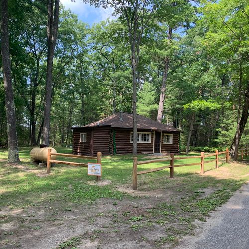 Exterior: a full view of the cabin, showing the parking area as well.