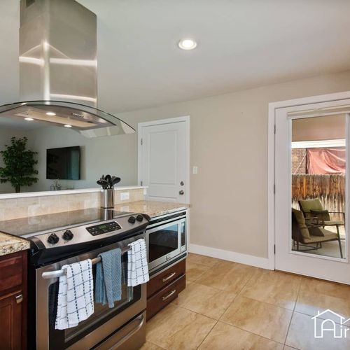 Bring a touch of warmth and style to your meals with the stunning kitchen outfitted with stainless steel appliances.