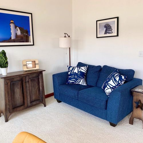 Living room:  the home has a large and lovely living room with comfy furniture, a gas fireplace, a desk, a large television with free living streaming, and great views of betsie lake!