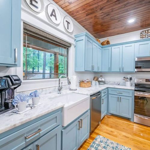 The modern kitchen offers a stove, oven, microwave, farmhouse sink and more!