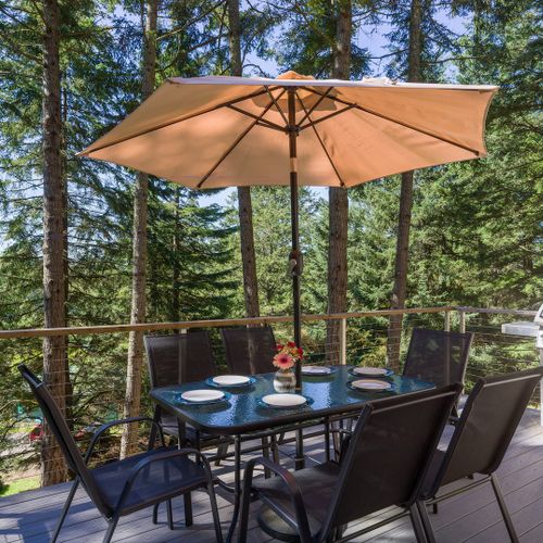 The patio has a table with an umbrella and a grill nearby—perfect for sunny breakfasts, evening BBQs, or a peaceful cup of coffee outside.