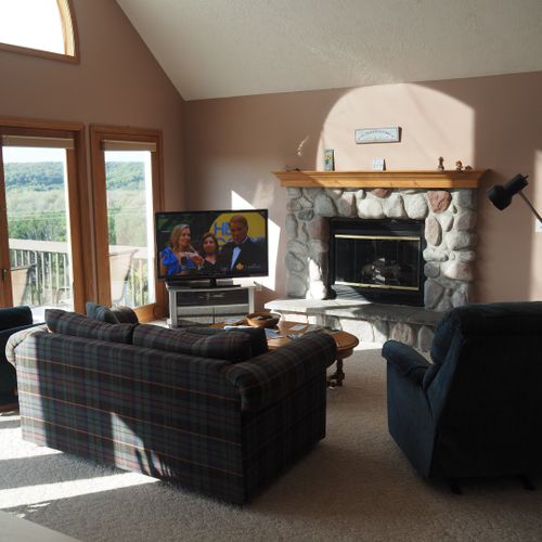 Living room #1 (main floor):  the home has a cozy living room with a gas fireplace and great views of the surrounding hills.