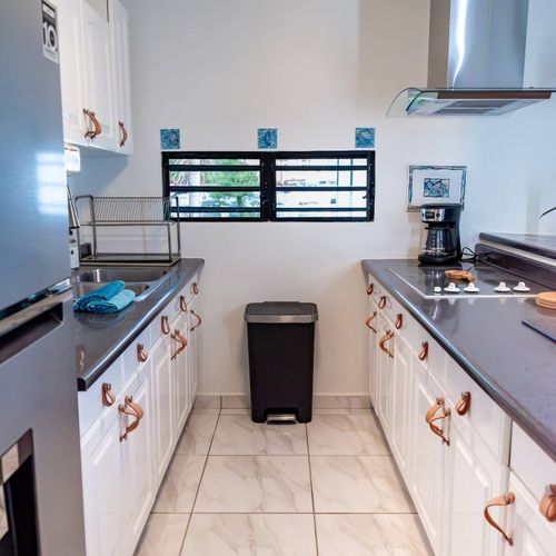 Prepare your favorite meals in our well-appointed kitchen! Featuring a full-sized refrigerator, stovetop, and ample counter space, it has everything you need for a comfortable stay.