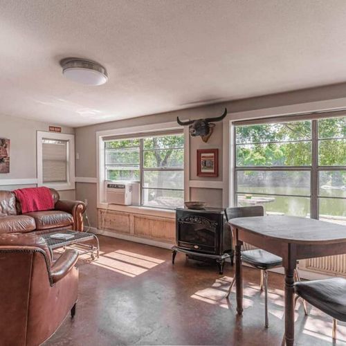 The cabin features bright, open plan living with riverfront views