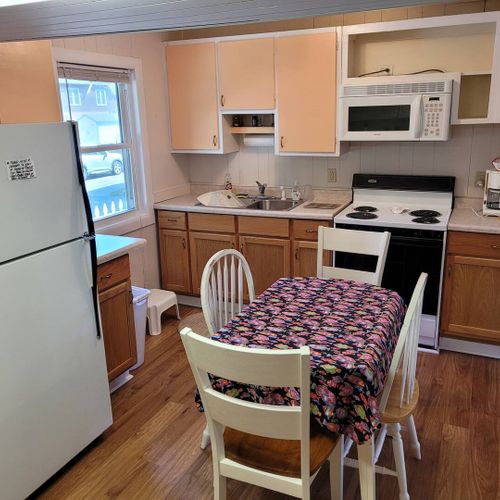 KITCHEN AND DINING AREA:  Full kitchen with a good supply of cooking and dining utensils.  Also includes dining area and washer and dryer.