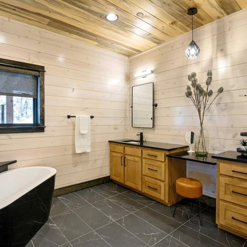 Private full bath with oversized soaking tub to unwind in.