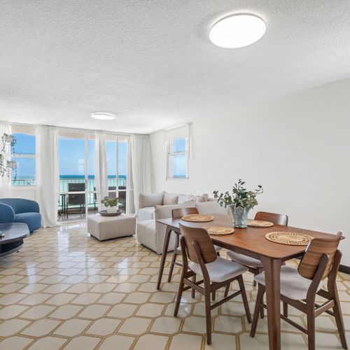 Embrace coastal living! The spacious living area boasts floor-to-ceiling windows, seamlessly blending indoor comfort with the magnificent oceanfront scenery.