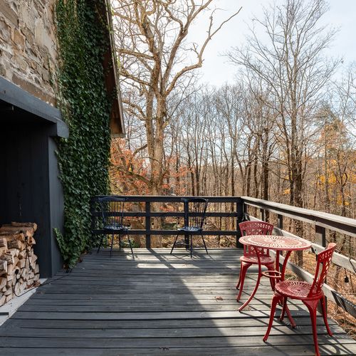 Enjoy the second story porch, the river lying just beyond the trees.