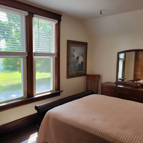 Bedroom #3 (second floor):  features a queen-size bed, dresser, large mirror, nightstand, and closet.