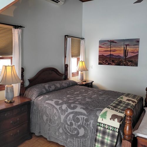 Bedroom #2 (second floor):  very large bedroom features a queen-size bed, walk-out deck, chair, 2 nightstands, 2 lamps, 2 dressers, ceiling fan, television, and private en suite full bathroom