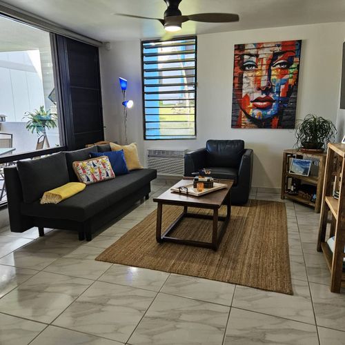 Our modern and inviting living area is your perfect retreat. Sink into the plush sofa or armchair, enjoy the artistic touches, and feel at home in this bright and comfortable space.