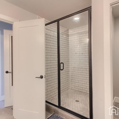 Unwind in the master en suite bathroom and walk in shower fitted with glossy subway tiles, mosaic stone floors and glass door enclosure.