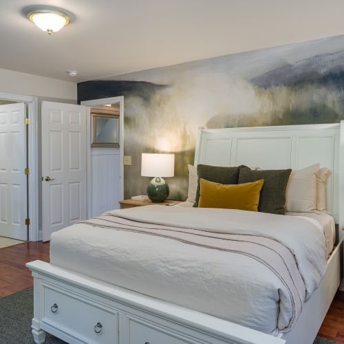 Forest Room with the warmth of a Pacific Northwest mural and green tones throughout the room.