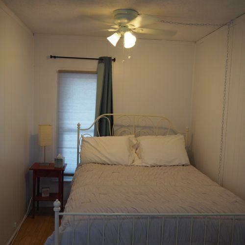 Bedroom:  the bedroom is small, but comfy and cozy, with a super comfortable pillow-top queen-size bed, nightstand, dresser, lamp, ceiling fan, and closet.