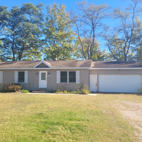 OVERVIEW:  The front of the home in late summer.