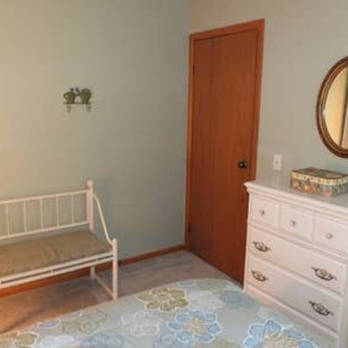Bedroom #2: features a full-size bed, chair, nightstand, lamp, dresser, and closet.
