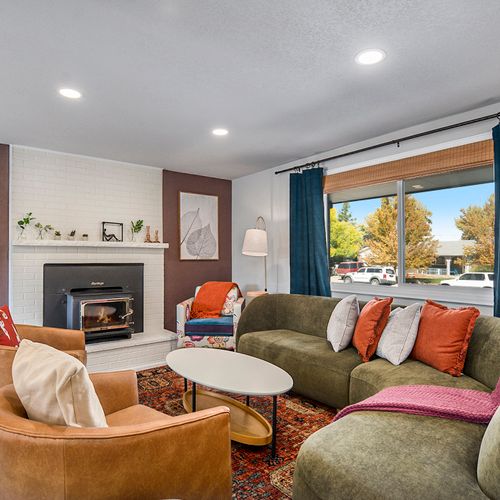 A vibrant and stylish main living room, filled with bold colors and chic decor, perfect for relaxing or entertaining.