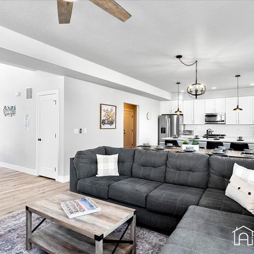 - relax on the plush sectional with clear sightlines to the bright and spacious kitchen
- modern finishes and neutral tones make the open layout feel fresh and inviting
- perfect setup for socializing, movie nights, or family fun