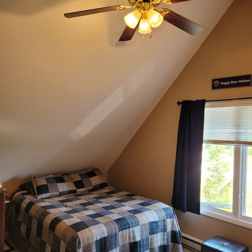 BEDROOM #2 (SECOND FLOOR):  Features a queen-size bed, 2 single beds, ceiling fan, a dresser, mirror, 2 nightstands, lamp, stool, and private live streaming television (via Sling).