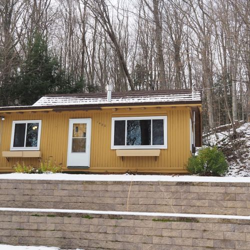 Exterior:  the outside of the cabin in the winter.